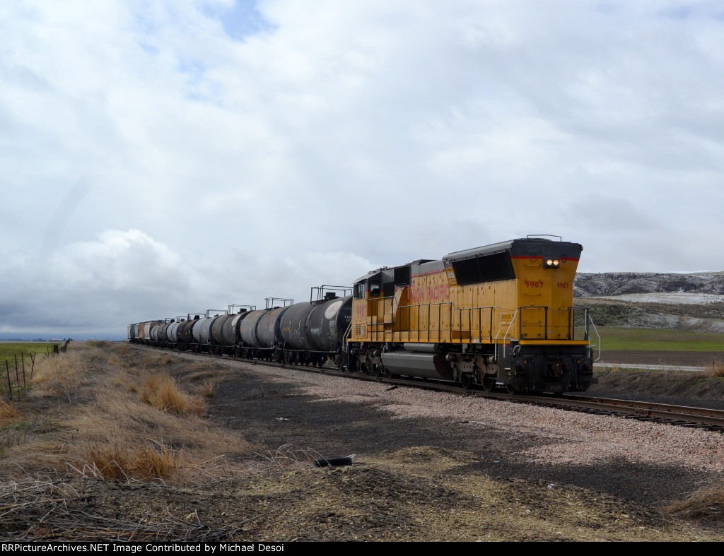 UP SD59MX #9907, running LHF, leads the southbound Cache Valley Local (LCG-41E) approaching the W. 4600 N. at Cache Junction, Utah. April 15, 2022